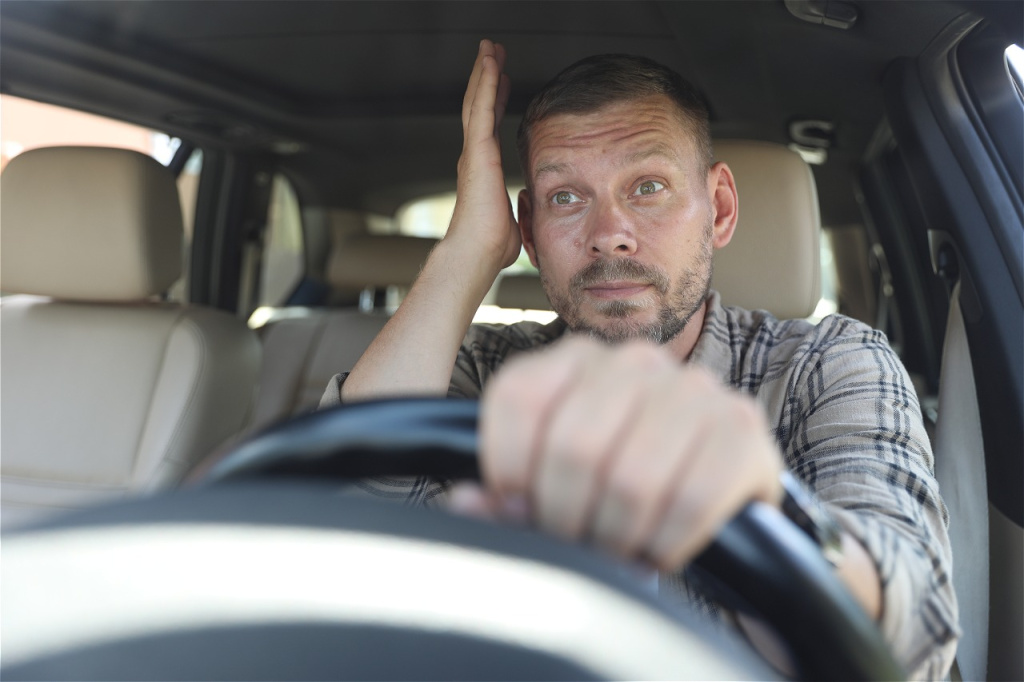 frustrated-man-driving-a-car-with-one-hand-on-stee-2026-09-01-00-22-12-utc.jpg