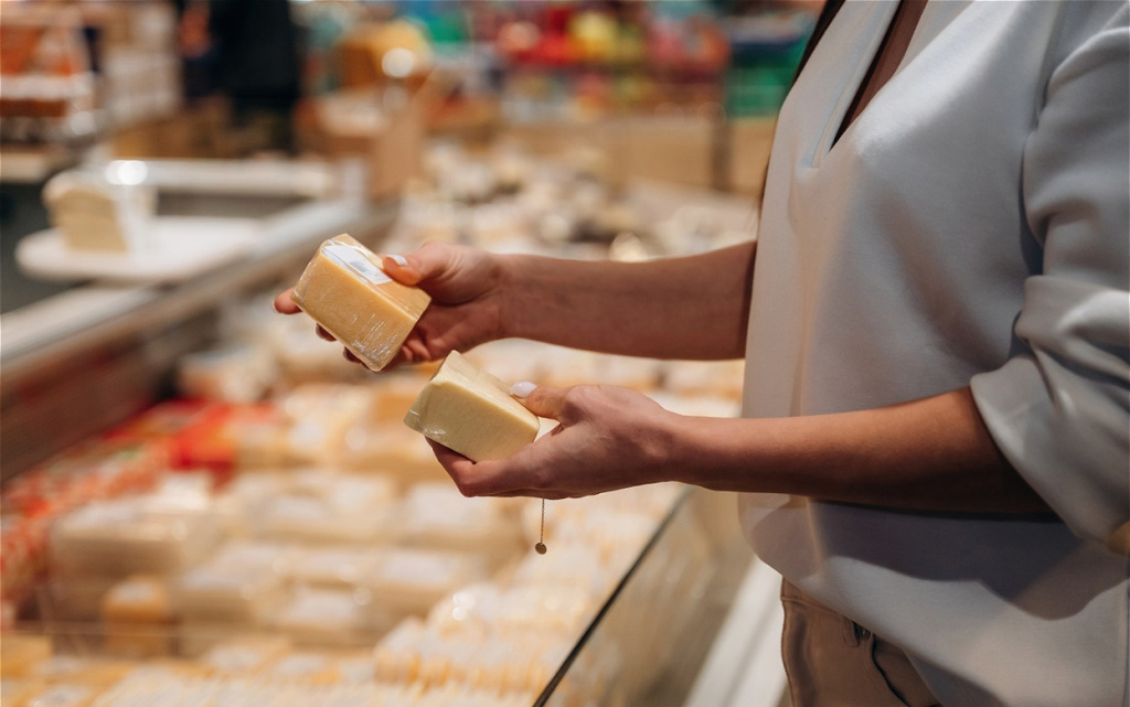 woman-selecting-cheese-in-a-grocery-store-holding-2026-04-14-14-58-43-utc (1).jpg
