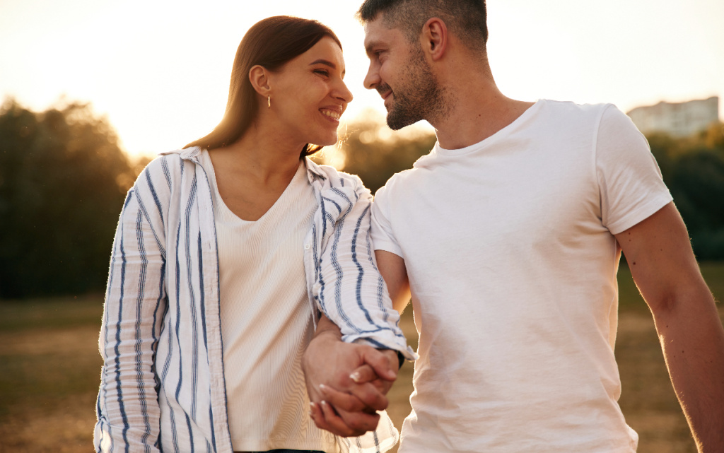 romantic-couple-holding-hands-and-smiling-outdoors-2026-09-22-03-06-00-utc (1).jpg