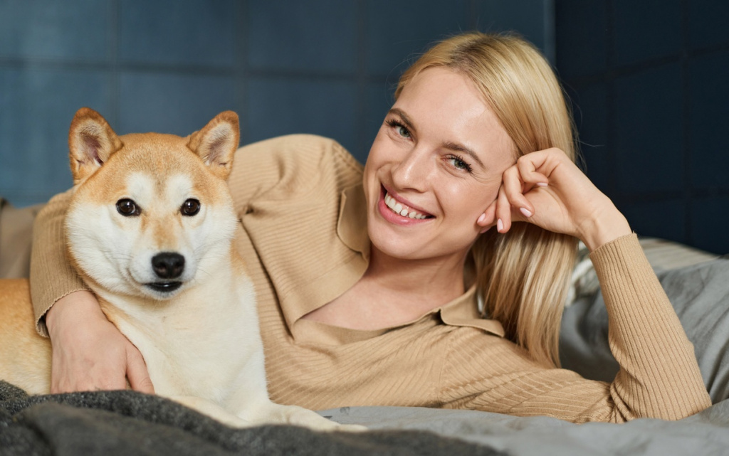 smiling-woman-cuddling-her-shiba-inu-dog-2026-03-18-15-48-11-utc (1).jpg