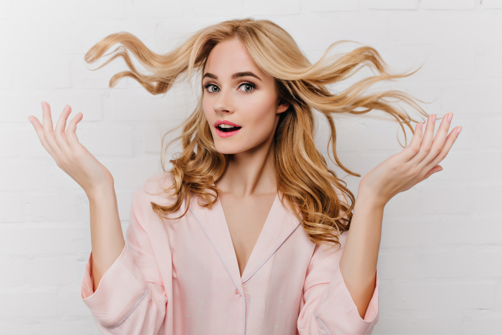 close-up-portrait-wonderful-lady-plays-with-her-blonde-long-hair-indoor-photo-stunning-european-female-model-pink-pajamas-isolated-white-wall.jpg