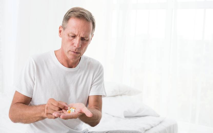 medium-shot-man-with-pills-bedroom (1).jpg