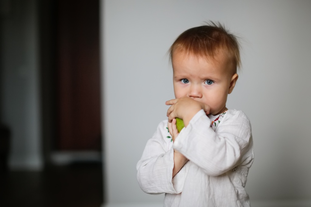 little-toddler-baby-eats-fruit-on-light-backgroun-2022-11-11-06-47-30-utc.jpg