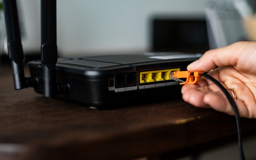 man-plugging-ethernet-cable-wireless-router (1).jpg
