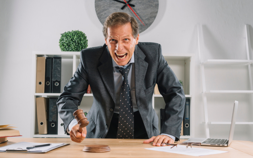 angry-mature-lawyer-hitting-mallet-sounding-block-courtroom (1).jpg