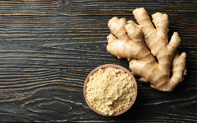 ginger-and-bowl-with-ginger-powder-on-wooden-backg-2021-08-31-15-05-30-utc.jpg