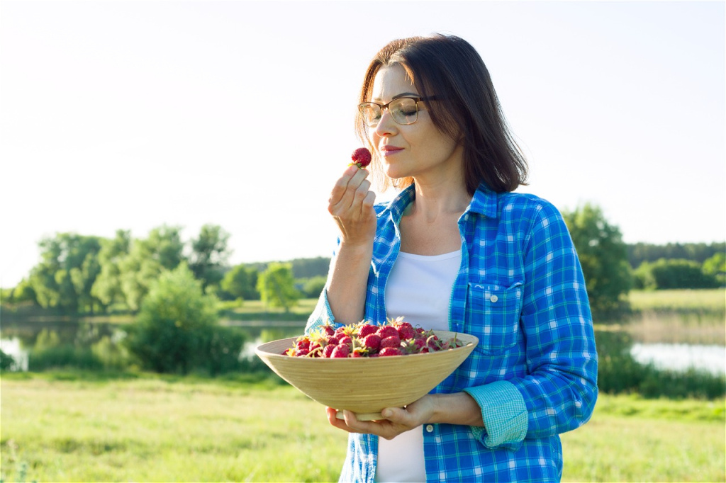 woman-enjoying-fresh-strawberries-in-a-rural-setti-2026-01-06-09-40-19-utc.jpg