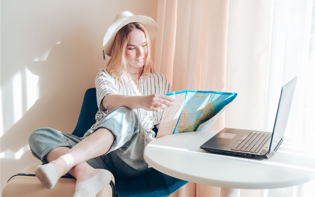 woman-plans-trip-with-map-and-laptop-2026-03-24-16-59-29-utc (1).jpg