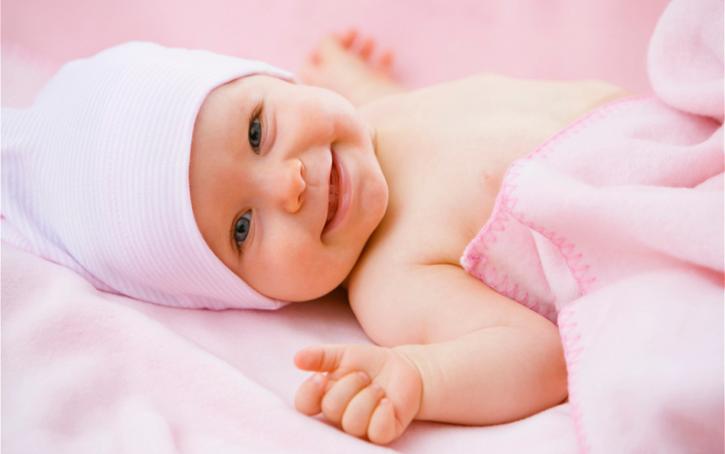 smiling-infant-wrapped-in-a-pink-blanket-2026-01-05-00-53-21-utc (1).jpg