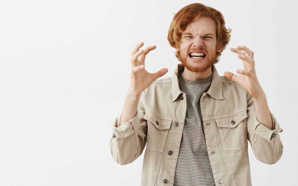 distressed-angry-bearded-redhead-guy-posing-against-white-wall (1).jpg