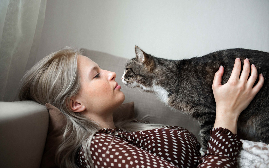 woman-cuddling-with-a-striped-tabby-cat-indoors-2026-03-19-22-09-15-utc (1).jpg