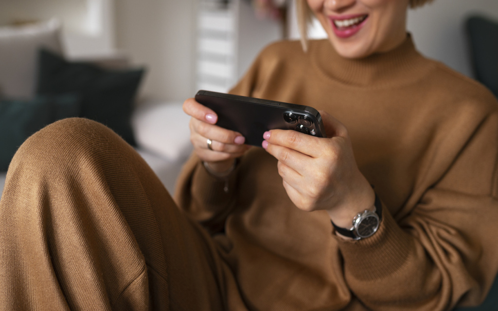 high-angle-woman-playing-with-her-phone (1) (1).jpg