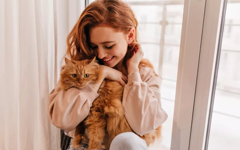 relaxed-smiling-girl-playing-with-her-fluffy-cat-indoor-shot-amazing-lady-holding-pet (1).jpg