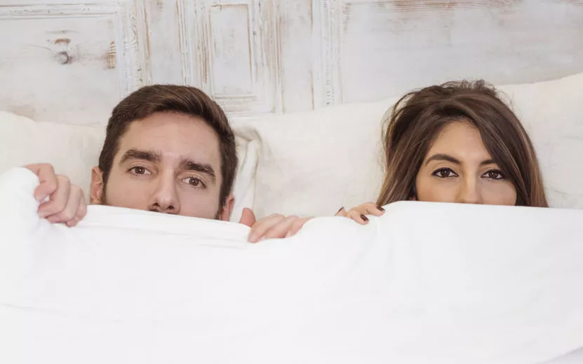 couple-hiding-white-blanket.jpg