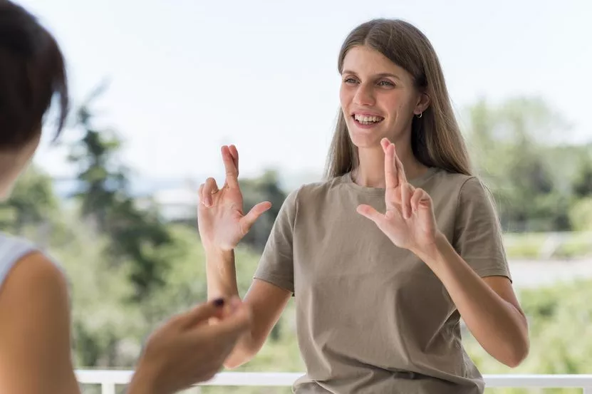 smiley-woman-communicating-through-sign-language-while-outdoors.jpg smiley-woman-communicating-through-sign-language-while-outdoors.jpg