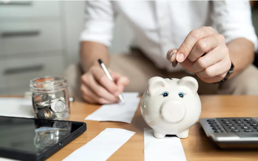 savings-and-finance-concept-man-putting-money-coi-2024-01-23-22-55-14-utc (1).jpg