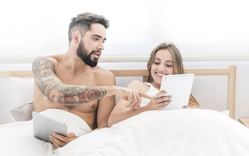 young-couple-sitting-bed-us.jpg