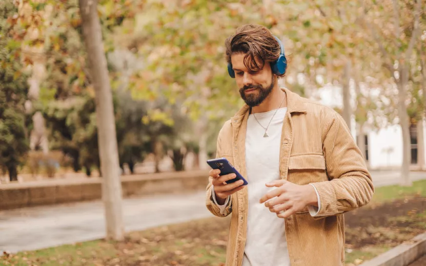 z-gen-caucasian-man-listening-to-music-in-park-2023-11-27-04-53-30-utc.jpg