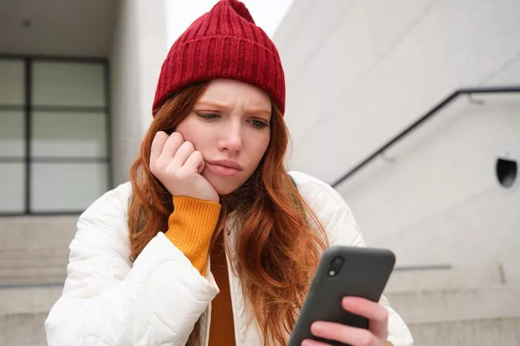 portrait-sad-redhead-girl-looks-upset-disappointed-smartphone-screen-reads-bad-news-text-m_1258-147056.jpg