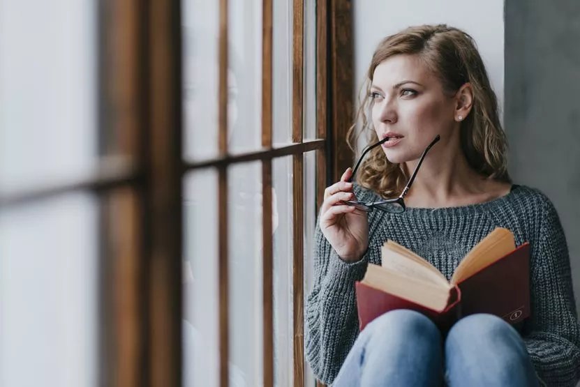 woman-with-book-glasses-thinking.jpg