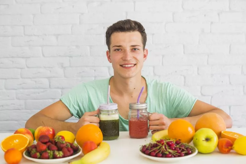 attractive-young-man-holding-green-red-smoothie-jars-with-colorful-fruits-table.jpg attractive-young-man-holding-green-red-smoothie-jars-with-colorful-fruits-table.jpg
