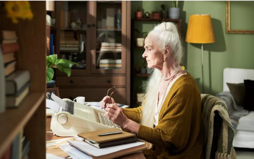 elderly-woman-typing-typewriter-home-office_274679-52655.jpg