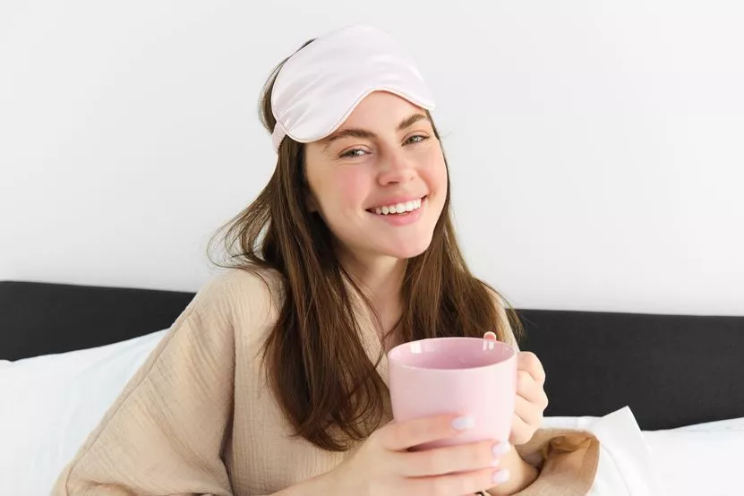 portrait-beautiful-woman-relaxing-bed-waking-up-having-her-morning-cup-coffee.jpg