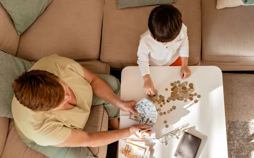 senior-woman-and-little-child-counting-paper-money-2023-11-27-04-49-37-utc (1).jpg