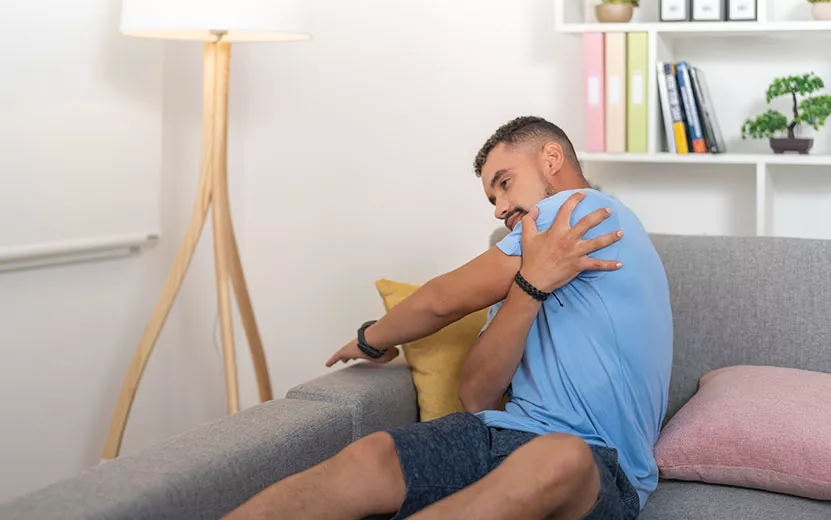 young-man-with-back-pain-doing-stretching-exercise-2023-04-28-00-50-57-utc1.jpg