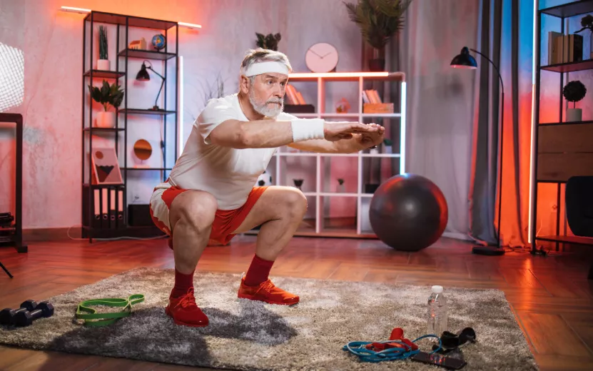 senior-man-doing-squats-at-home-during-evening-tim-2021-09-04-13-08-37-utc (1).jpg